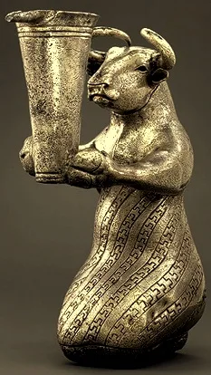 تندیس نقره‌ای گاو نشسته یکی از اشیای باستانی است که متعلق به دوران نیا-ایلامی است. قدمت این تندیس ۲۹۰۰ تا ۳۱۰۰ سال پیش از میلاد است. سر و دستان موجود، گاو است و تن آن انسان می‌باشد. تندیس نقره‌ای گاو نشسته در جنوب غرب ایران کشف شده‌است. این تندیس ۱۶٫۳ سانتی‌متر ارتفاع دارد. مجسمه نقره‌ای لباس مخصوصی را بر تن کرده که دارای الگوی پله-پله می‌باشد و به شکلی راه راه آن را مزین کرده‌است. گاو در حال گرفتن یک جام با دهانه لوله‌ای است. تندیس نقره‌ای گاو نشسته در موزه متروپولیتن نیویورک نگهداری می‌شود . مجسمه گاو ایلامی با لباسی منقوش به طرح پلکانی و جام دهانه داری که در دست دارد، آمیختگی جالبی از ویژگی‌های انسان و حیوان را نمایش می‌دهد. البته این گونه نمایش ترکیبی (حیوان در نقش انسان) در دوره ایلامی مقدم معمول بوده و احتمالاً نشان نوعی قدرت فوق طبیعی بوده که از طرف خدایان به پادشاهان اعطا می‌شده‌است. با اینکه کاربرد این تندیس کاملاً مشخص نشده‌است، نوع جام و طرح‌های حک شده روی لباس، بیانگر نوعی مراسم آیینی یا جشن مذهبی است. همچنین جنس نقره‌ای این مجسمه معروف که در عصر مس (حدود ۵۰۰۰ سال پیش) ساخته شده، علاوه بر هنرمندی قابل ستایش سازندگان آن، بیانگر پیشگامی تمدن ایلام در فناوری استخراج و ذوب فلزات گرانبها است .